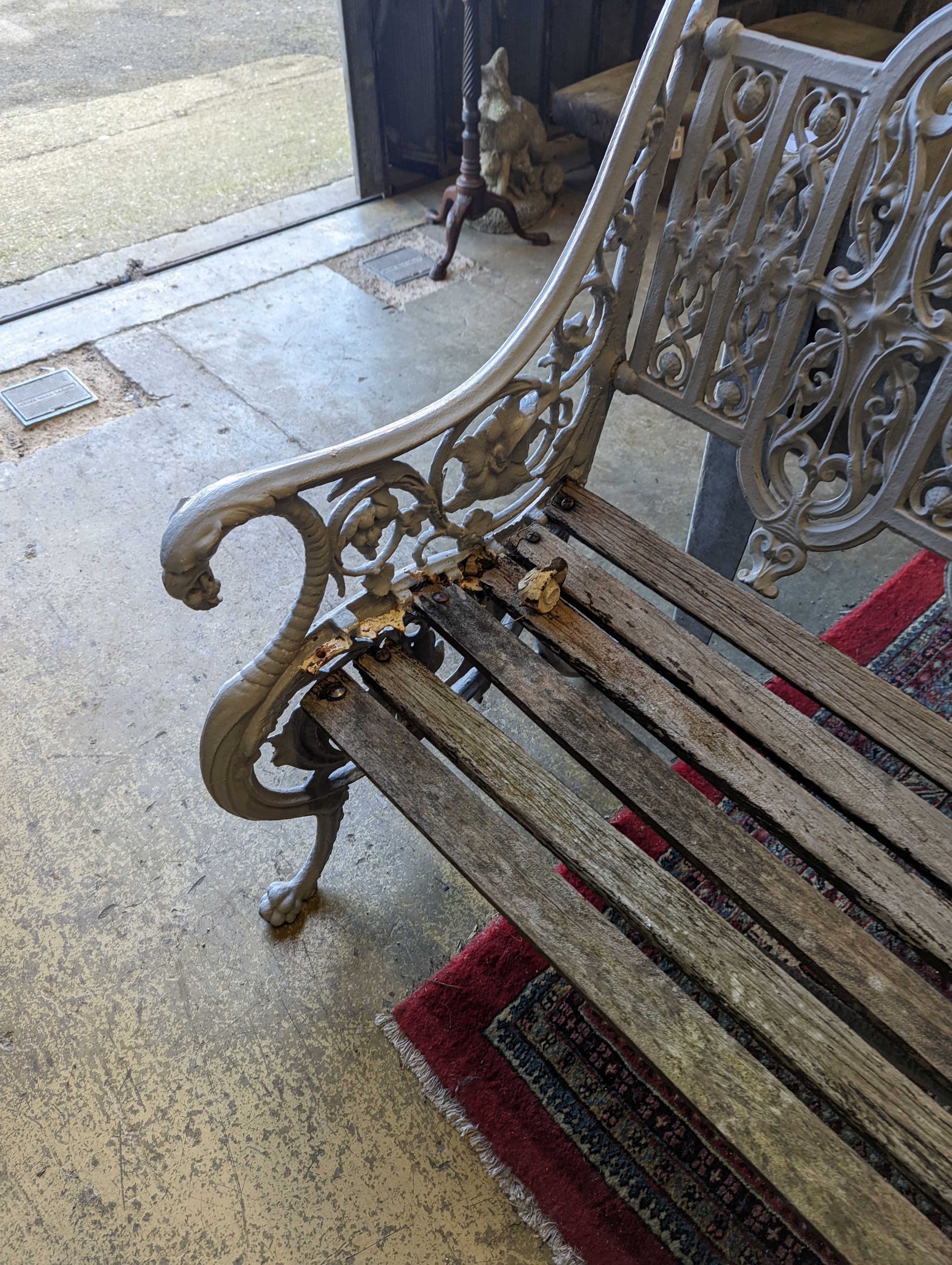 A Victorian Coalbrookdale cast-iron garden bench, length 156cm, depth 68cm, height 94cm (re-painted and seat in need of repair)